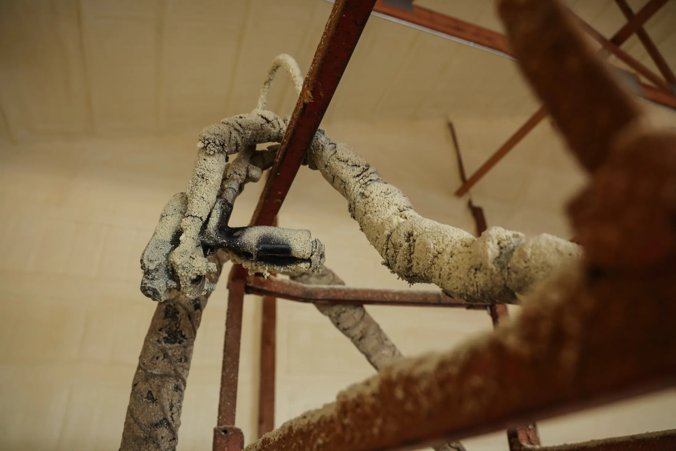 Spray hose and scaffold coated in overspray during a foam application